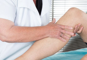 Therapist working with patient's knee - Orthopedics, Mountain Home, Arkansas